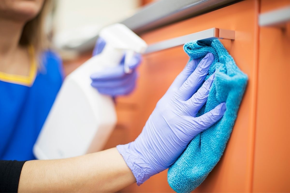 Professional domestic cleaner cleaning kitchen in Islington flat